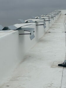 Commercial roof parapet edge detail showing precise installation work