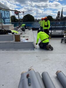 Commercial roof installation showing materials and early-stage roofing work