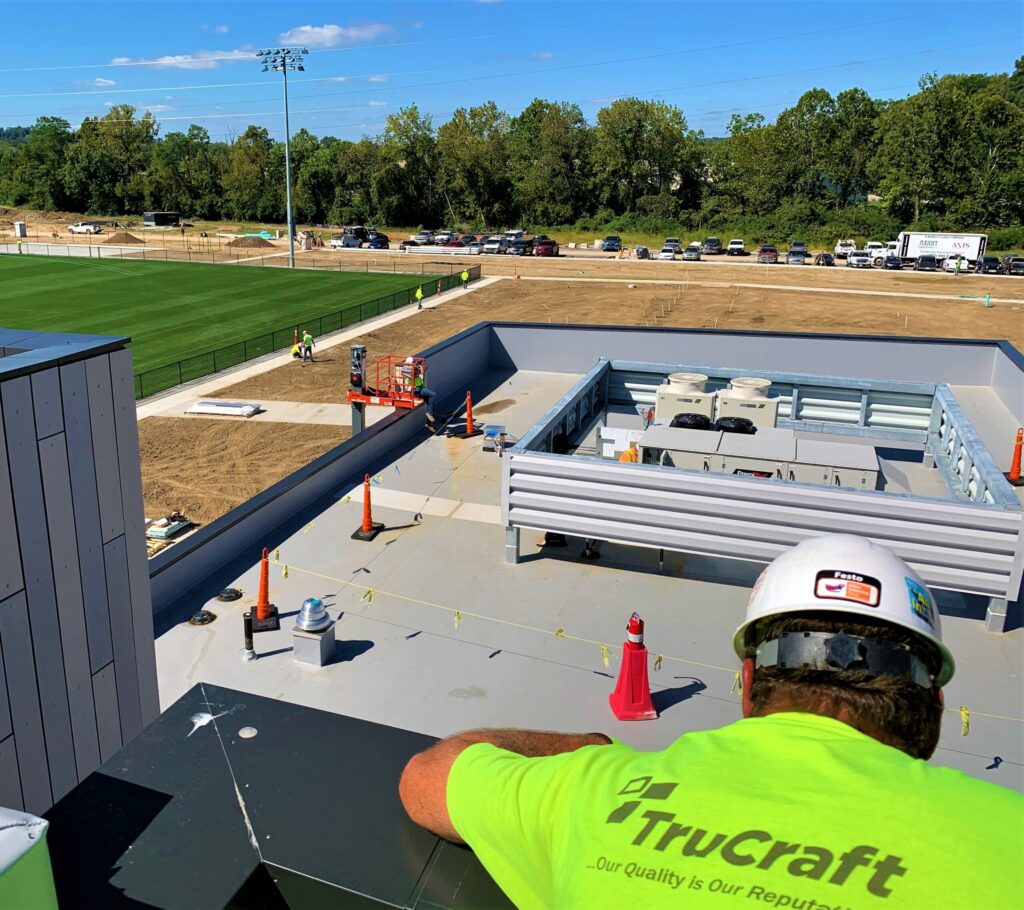 TruCraft team member evaluating a commercial roofing system in Cincinnati, Ohio