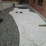 Commercial roofing installation at the University of Dayton Health & Wellbeing Center featuring an Elevate® modified bitumen roofing system with decorative stone in Dayton, OH.