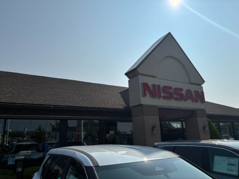 Asphalt shingle roof on commercial Nissan dealership